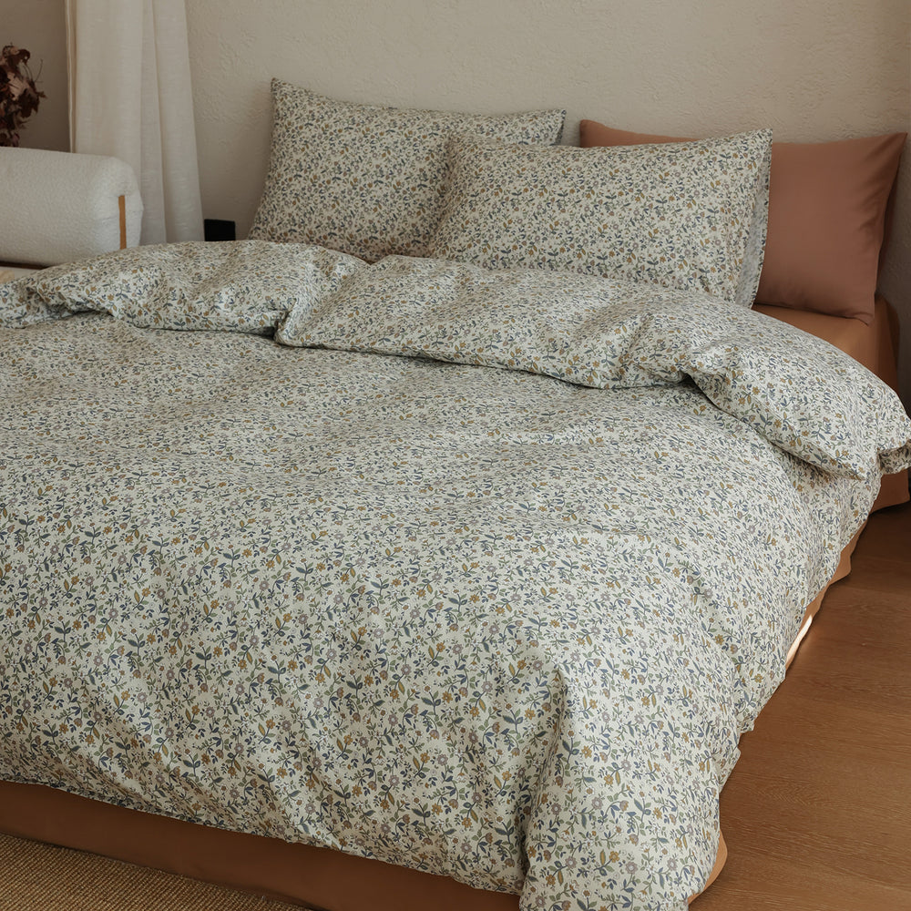 Ivory Olive Ditsy Floral Cotton Bedding Set – matching pillows and duvet in a softly lit bedroom - Roomden