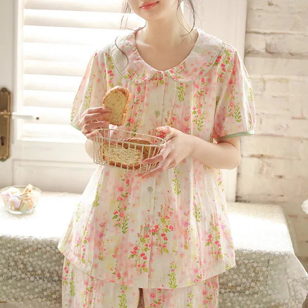 Lifestyle shot of model holding bread basket wearing vintage style floral cotton lounge set - RoomDen