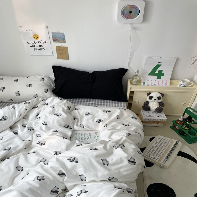 White panda print cotton bedding with a black pillow and gray check styling - Roomden
