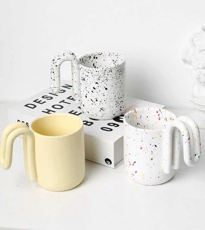 Three aesthetic mugs in Butter Yellow, Black Splatter, and Confetti Splatter styles - RoomDen
