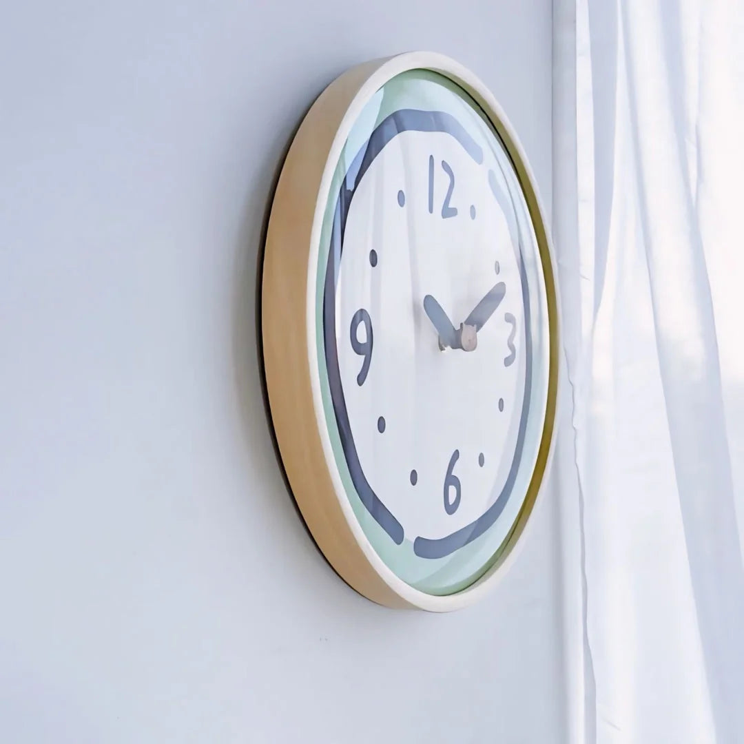 Side view of the Green Doodle Wall Clock hanging on a wall next to a white curtain.