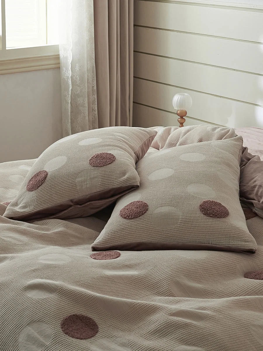 Close-up of the Dusty Rose Polka Dot pillow shams, showcasing the raised dot texture against the waffle weave. - RoomDen