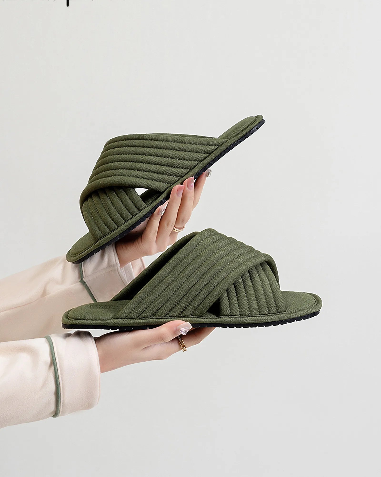 Close-up profile view of Olive Green cotton slippers held in hand