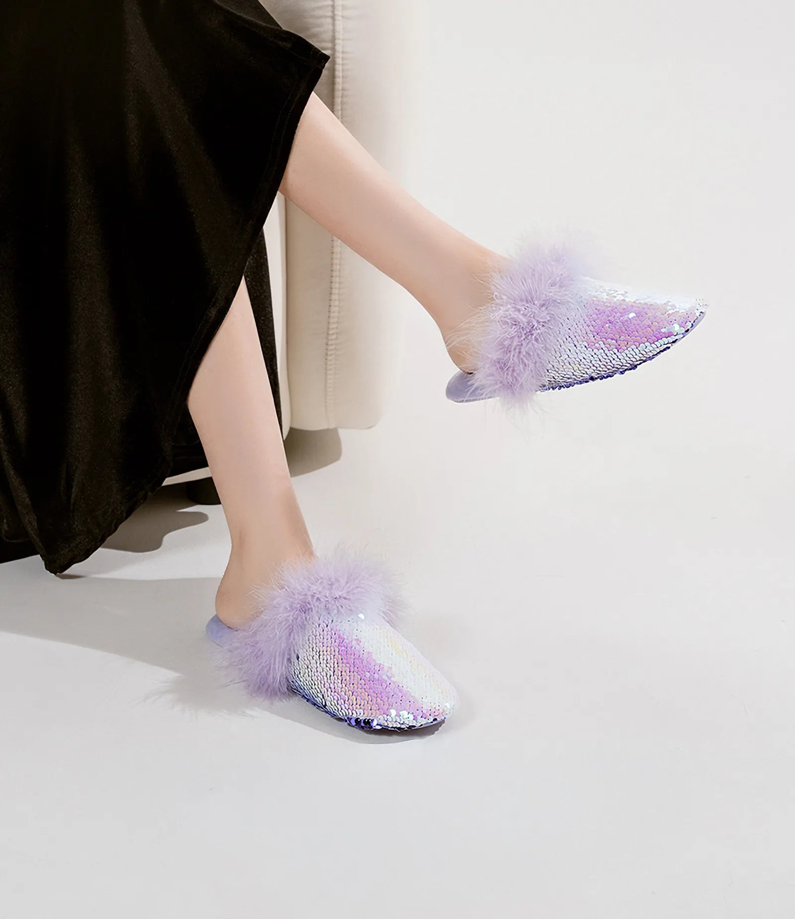 Close up of iridescent purple sequins and soft feather trim on slippers - RoomDen
