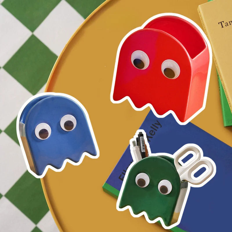Three Retro Ghost Ceramic Pen Holders in red, blue, and green on a yellow table with a checkered background - RoomDen.