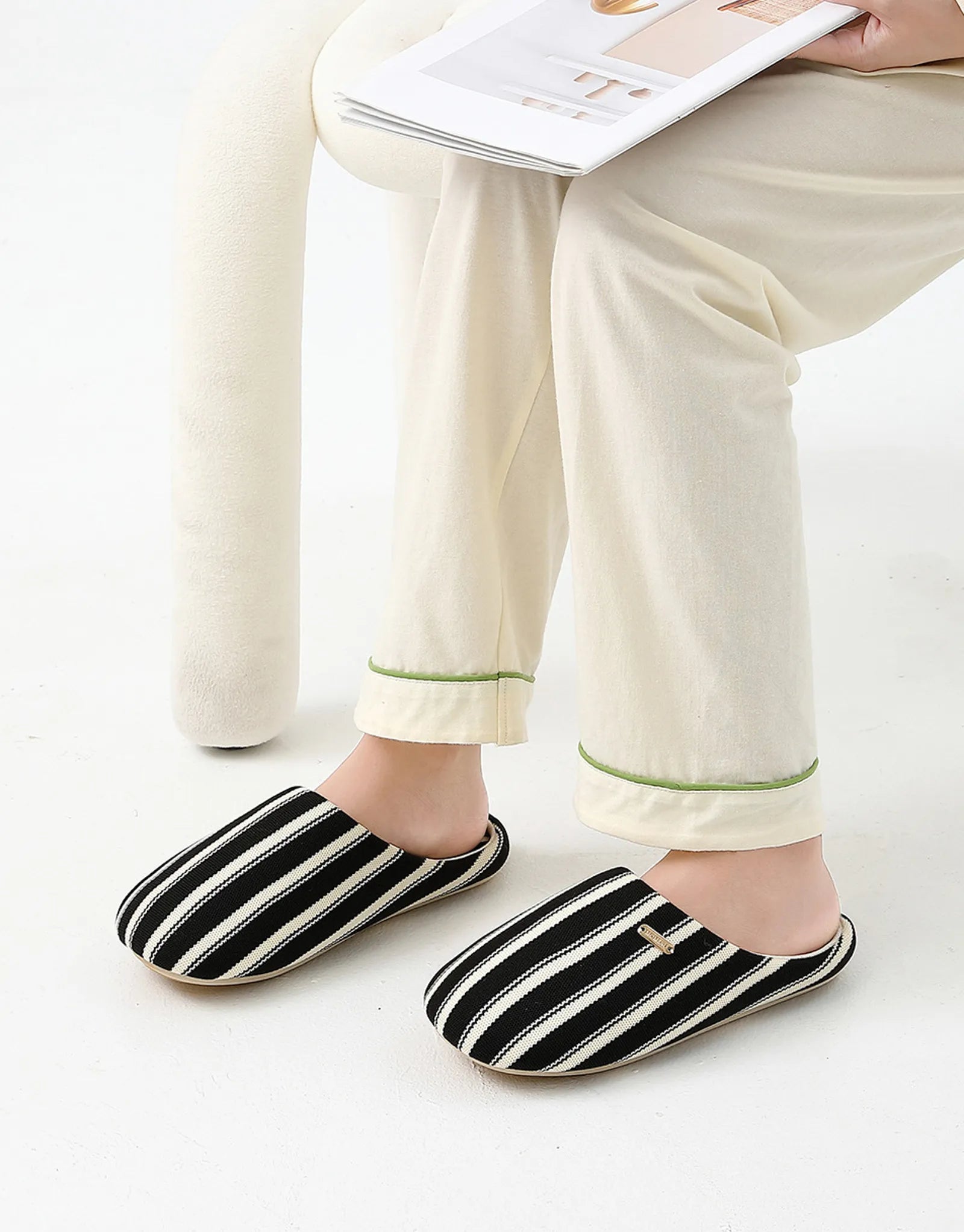 Model sitting wearing Black Striped Cotton Slippers - RoomDen