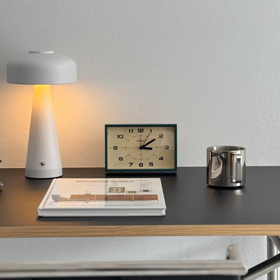 Forest Green Retro Analog Table Clock on a black desk with a modern lamp and book - RoomDen.