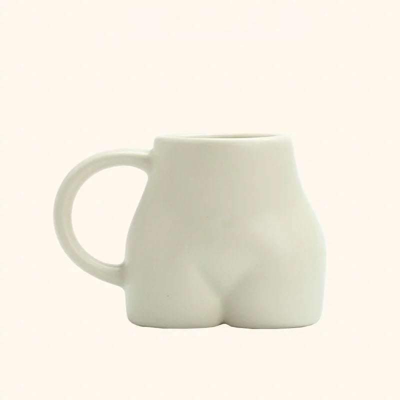 The pistachio green sculptural body ceramic mug with a matte finish on a white background. - RoomDen