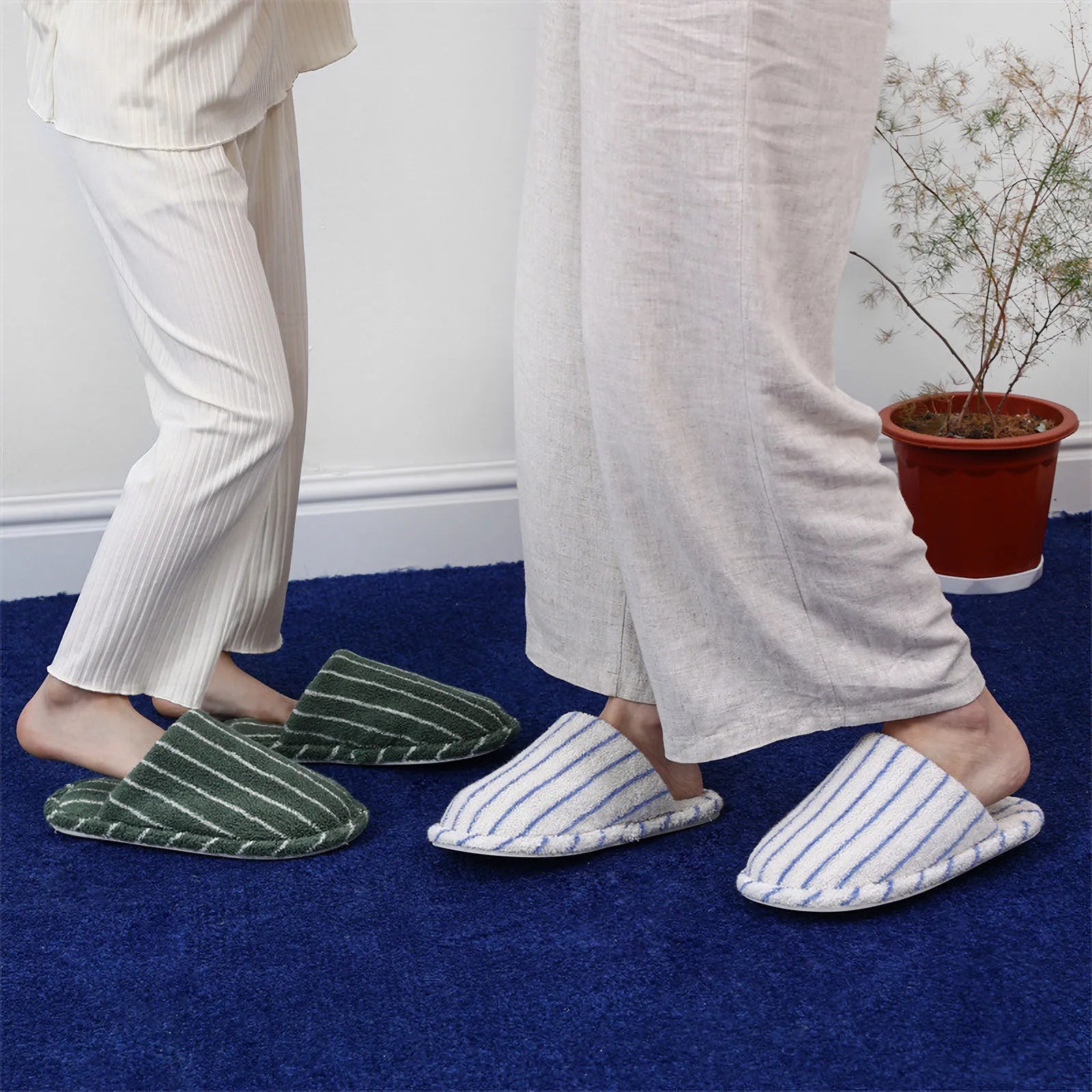 Two people standing wearing Green and White Striped and White and Blue Striped slippers