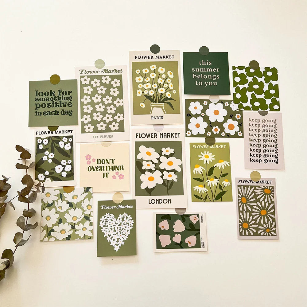 A full set of the Sage Green Botanical Wall Collage Kit, arranged on a white wall with a sprig of eucalyptus, showcasing various daisy and quote designs - RoomDen