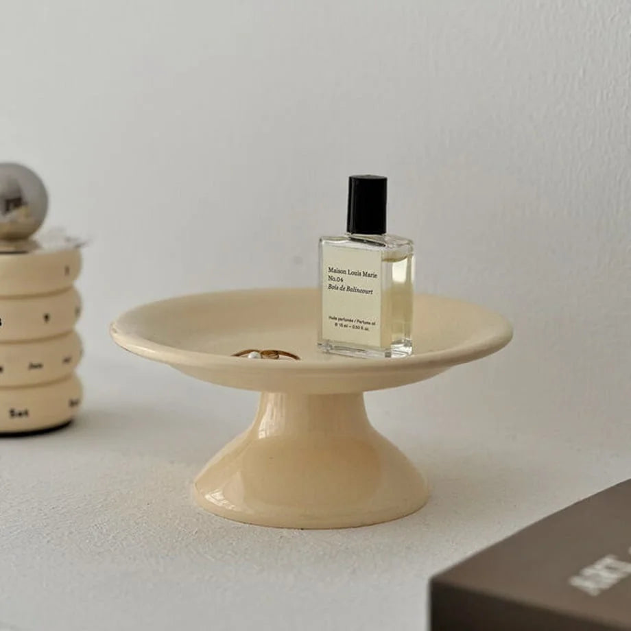 Close-up of the creamy beige pedestal jewelry organizer, showing its smooth finish and curved design. - RoomDen