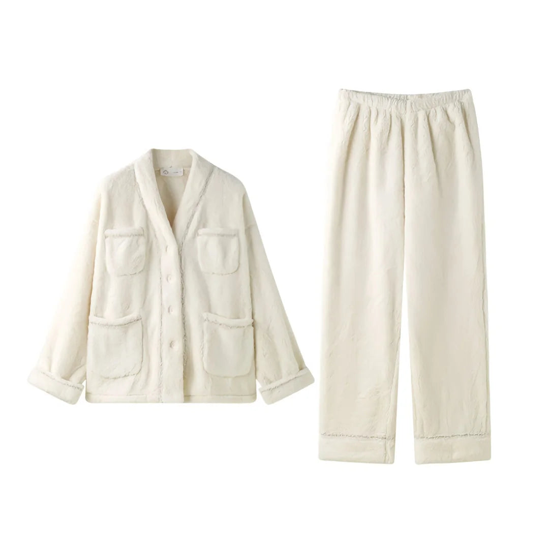 Flat lay of the cream flannel fleece pajama set, showing the button-up top and matching pants on a white background - RoomDen.