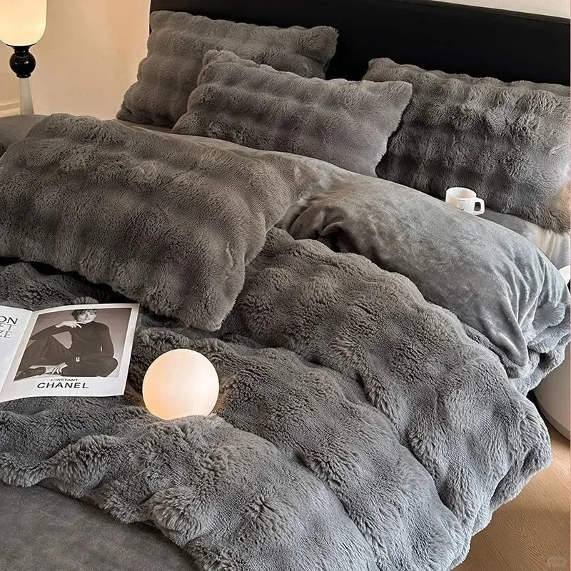 Lifestyle scene of the Charcoal Grey plush bedding with a magazine and warm light. - RoomDen