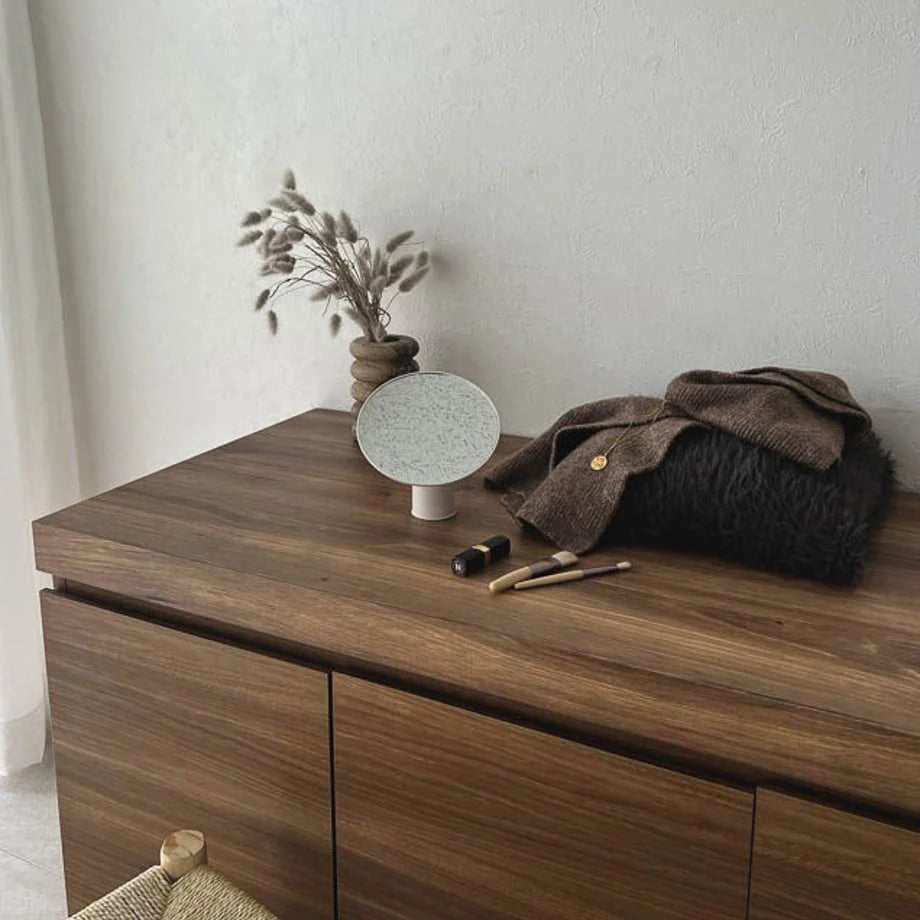 Lifestyle scene of the white rotating desktop mirror on a dark wood console table. - RoomDen