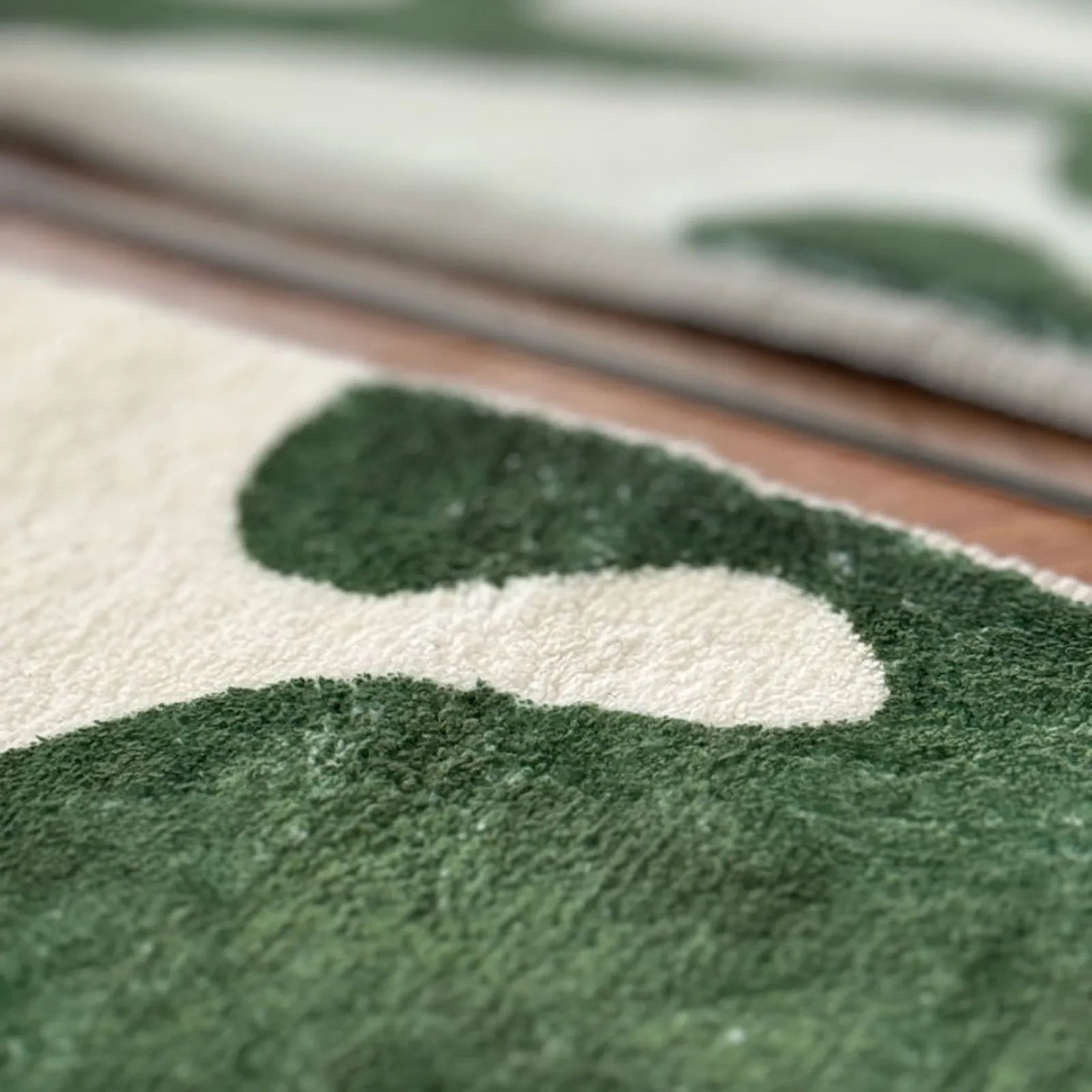 Extreme close up texture shot of the plush tufted polyester fibers in green and white