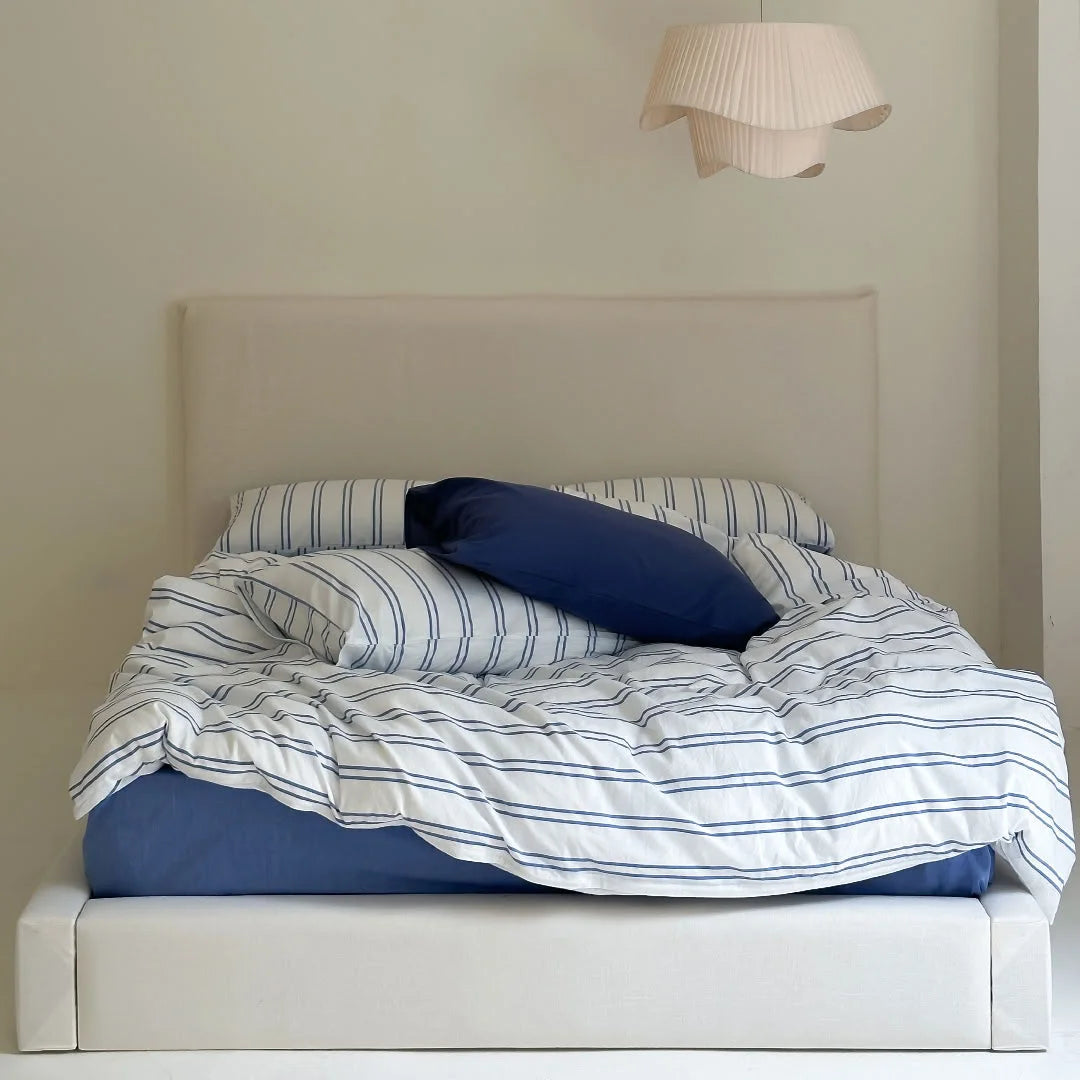 White and Blue Striped Bedding with Solid Navy Sheet - Side View
