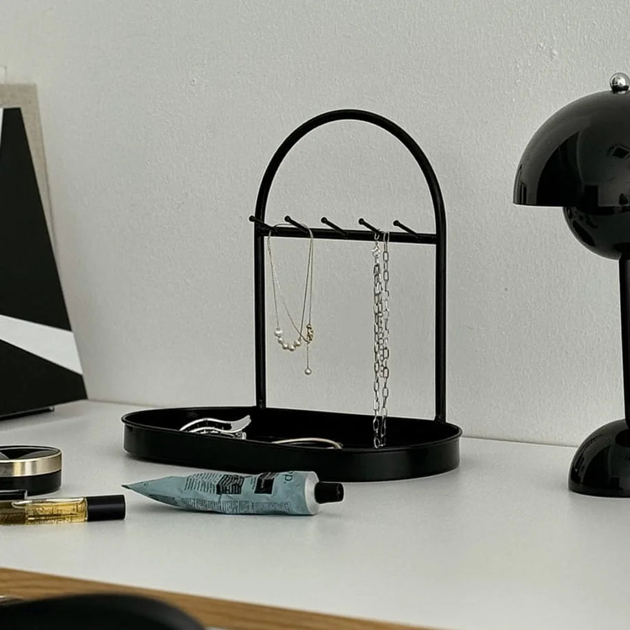 Front view of the Black Arched Metal Jewelry Organizer on a vanity. - RoomDen