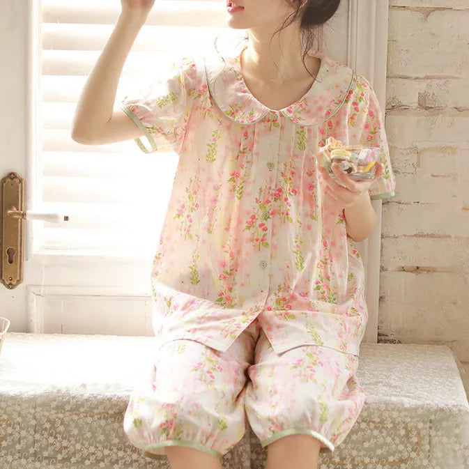 Girl sitting on window sill eating cookies wearing Coquette style floral pajamas close up - RoomDen