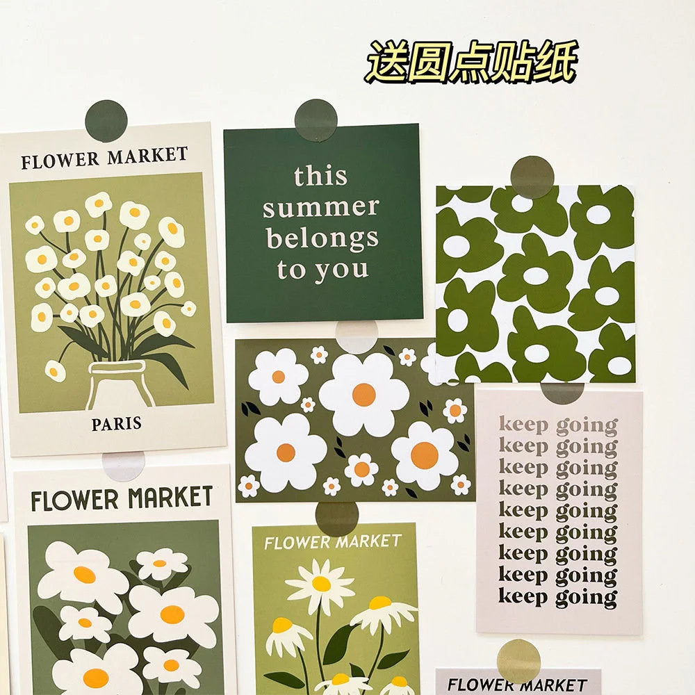Several prints from the floral wall art set, showing the included round stickers for easy application and the variety of designs - RoomDen