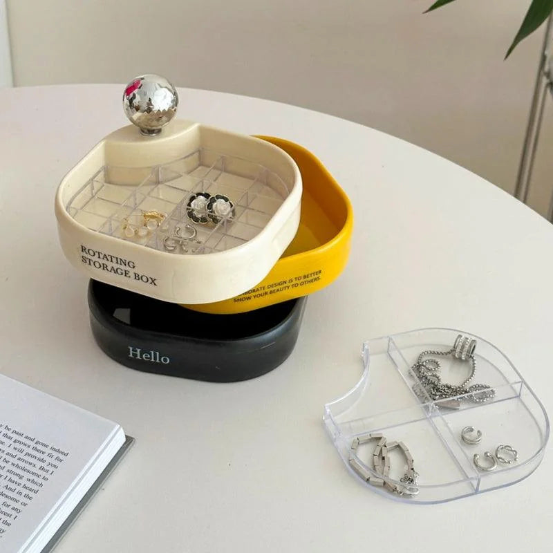 The tricolor rotating jewelry organizer with small earrings displayed in the top compartment. - RoomDen