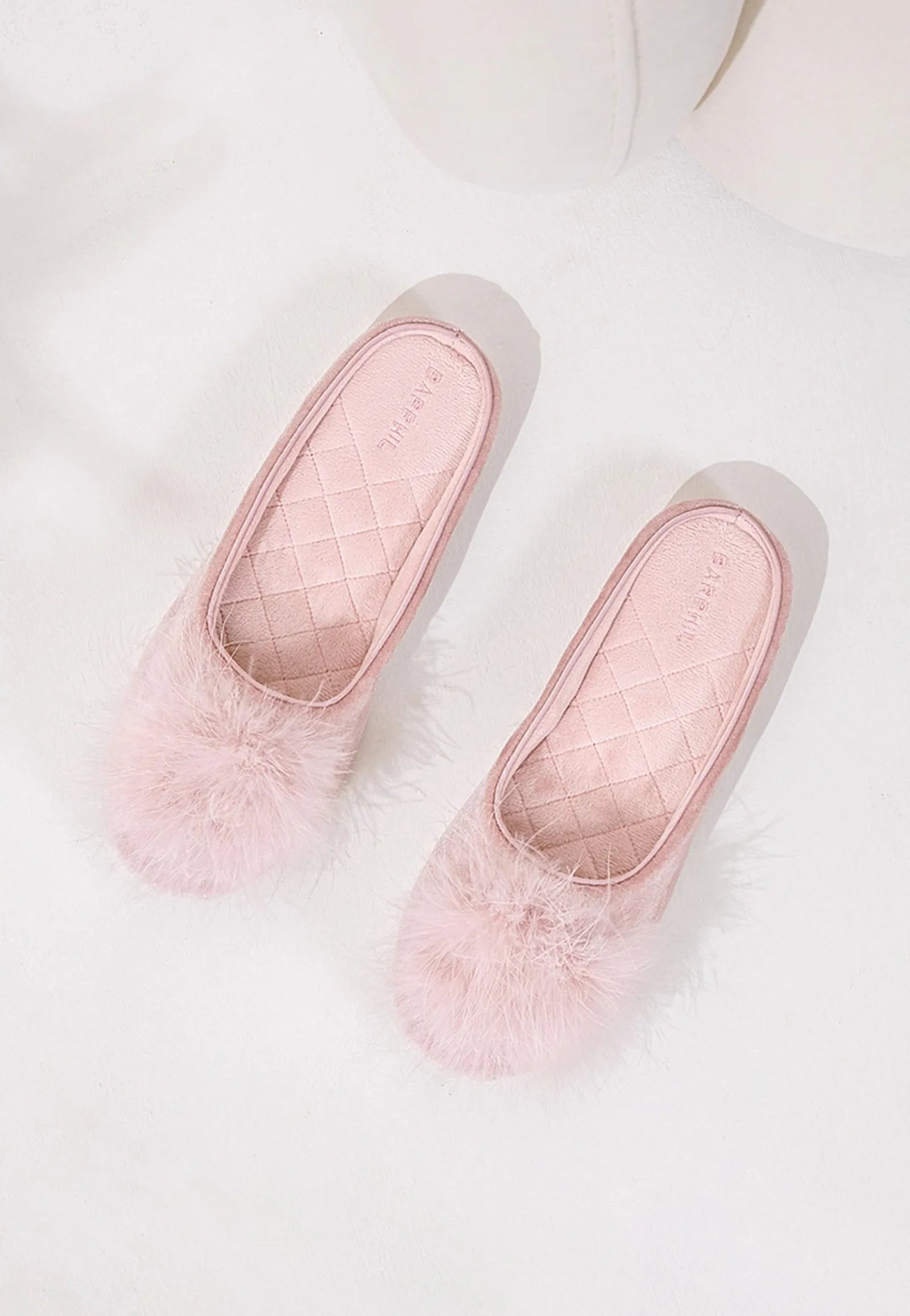 Top down view of pink house slippers showing quilted footbed - RoomDen