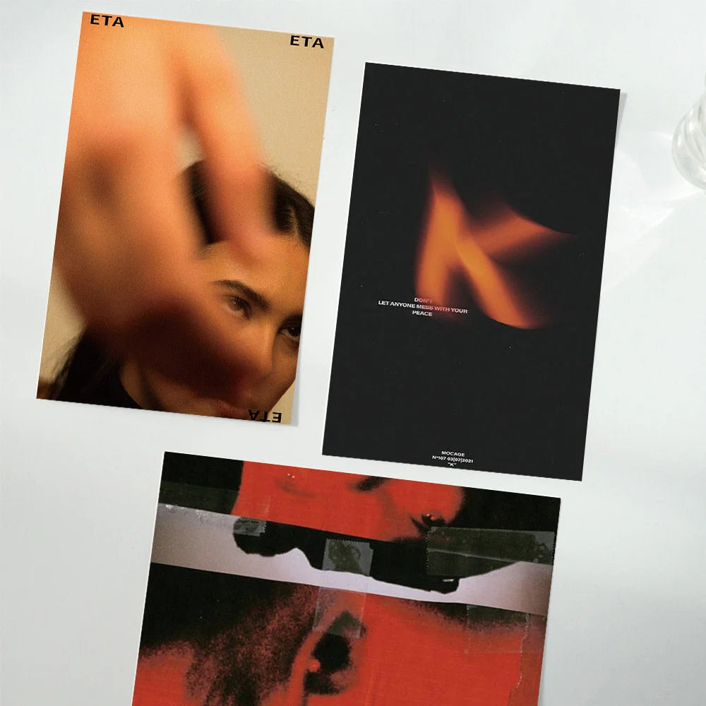 Three prints from the Moody Cinematic Wall Collage Kit laid flat, showing abstract red, flame, and portrait designs - RoomDen