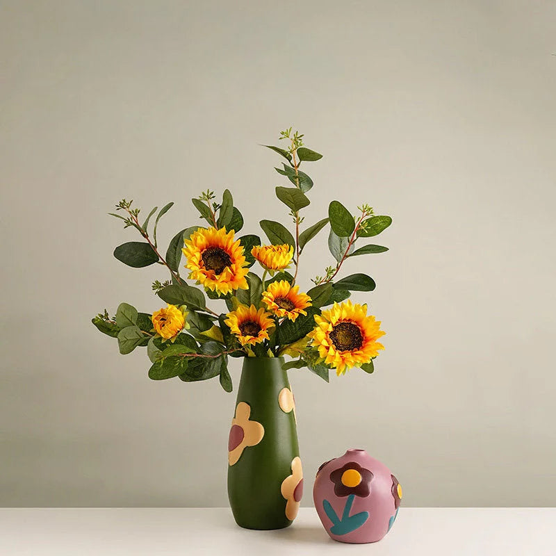 Olive Green and Dusty Mauve floral vases displayed on a white table, the green one holding sunflowers. - RoomDen