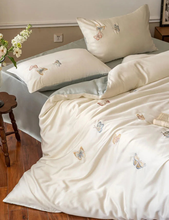 Angled view of the bed with the creamy beige and sage green Butterfly Embroidered Bedding Set.
