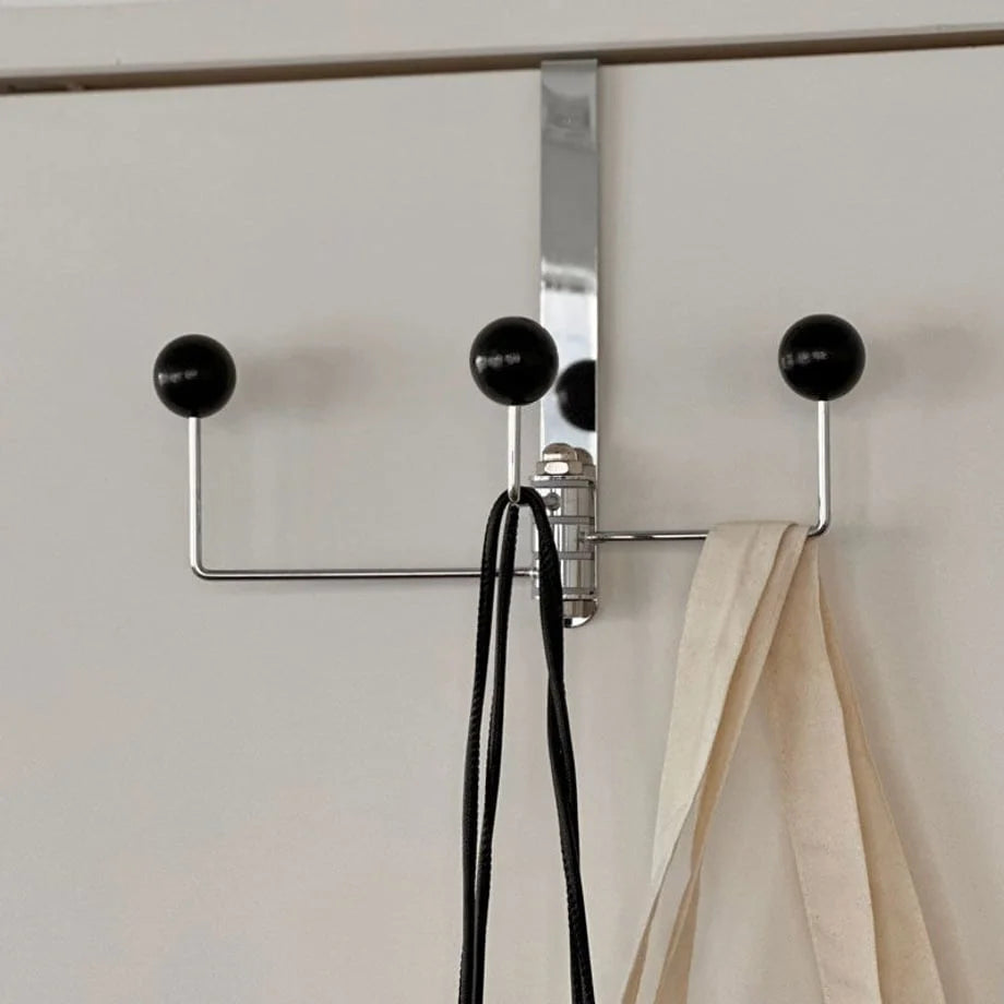 Close-up detail of the three black ball tips on the metal door hook rack - RoomDen