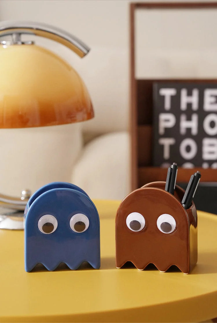 Blue and brown Retro Ghost Ceramic Pen Holders sitting on a yellow desk next to a retro lamp - RoomDen.