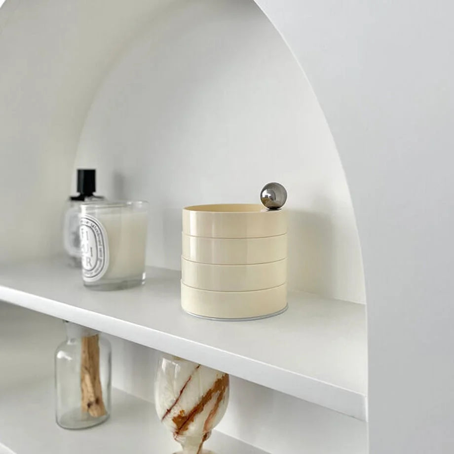 A full view of the closed Creamy Beige jewelry organizer on a modern white shelf. - RoomDen