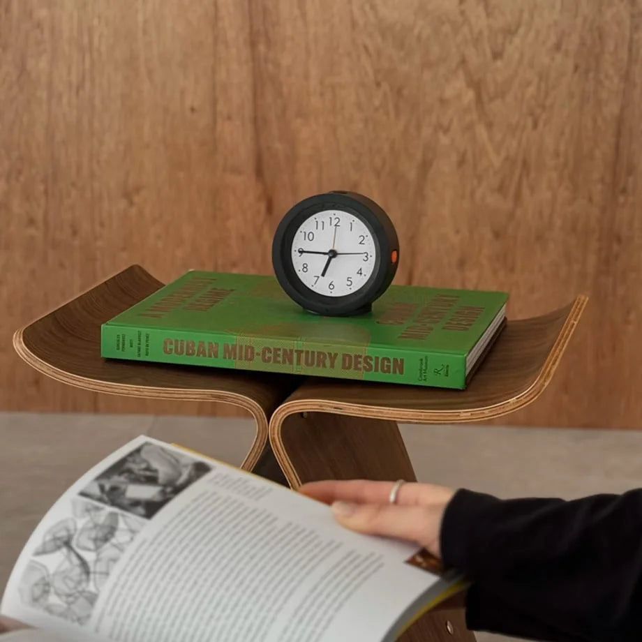 The black analog alarm clock adding a functional, vintage touch to a modern living space. - RoomDen
