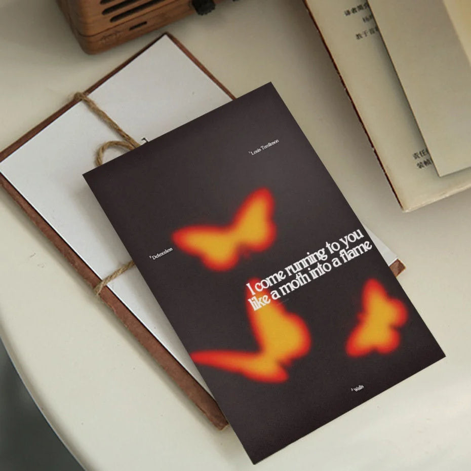 A single poster with glowing orange butterflies and the text 'I come running to you like a moth into a flame' from the collage kit. - RoomDen