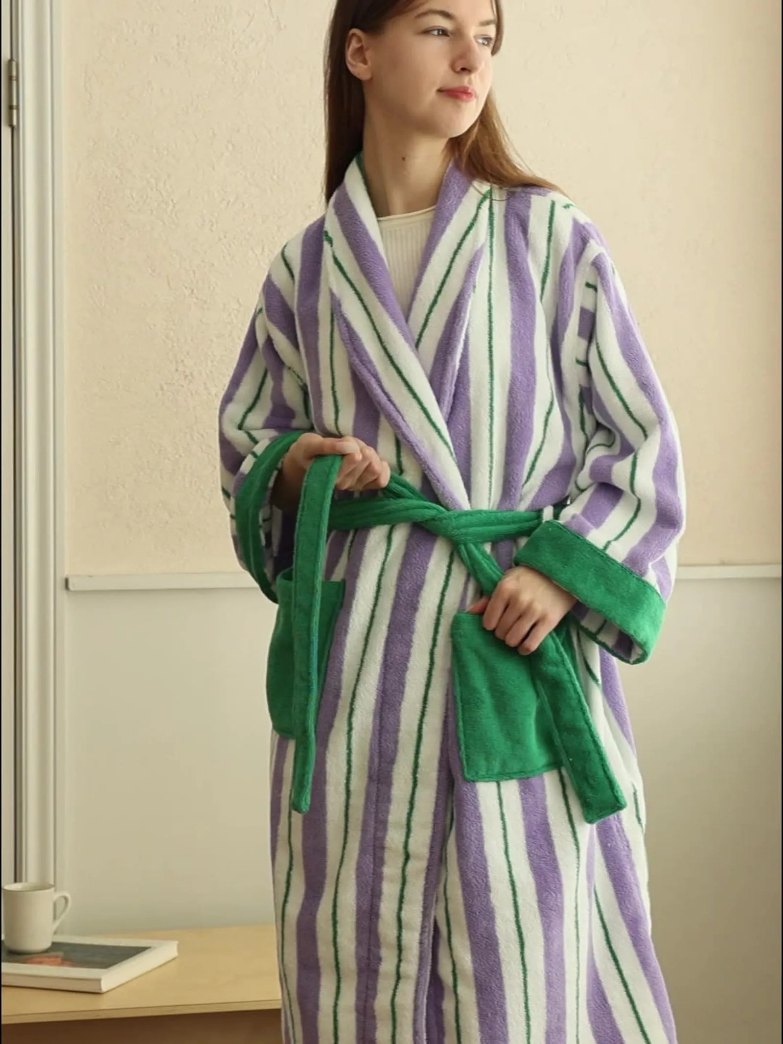 Front view of long-staple cotton bathrobe featuring purple stripes and green cuffs