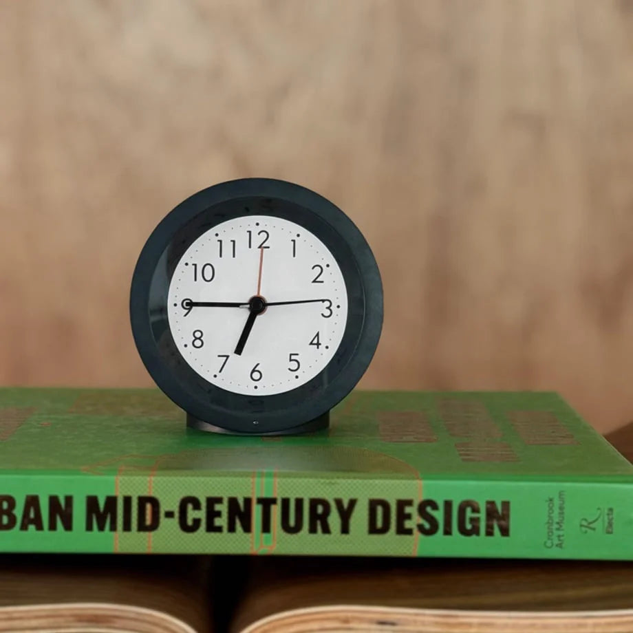 Front view of the black Minimalist Matte Analog Alarm Clock with its clean, readable face. - RoomDen