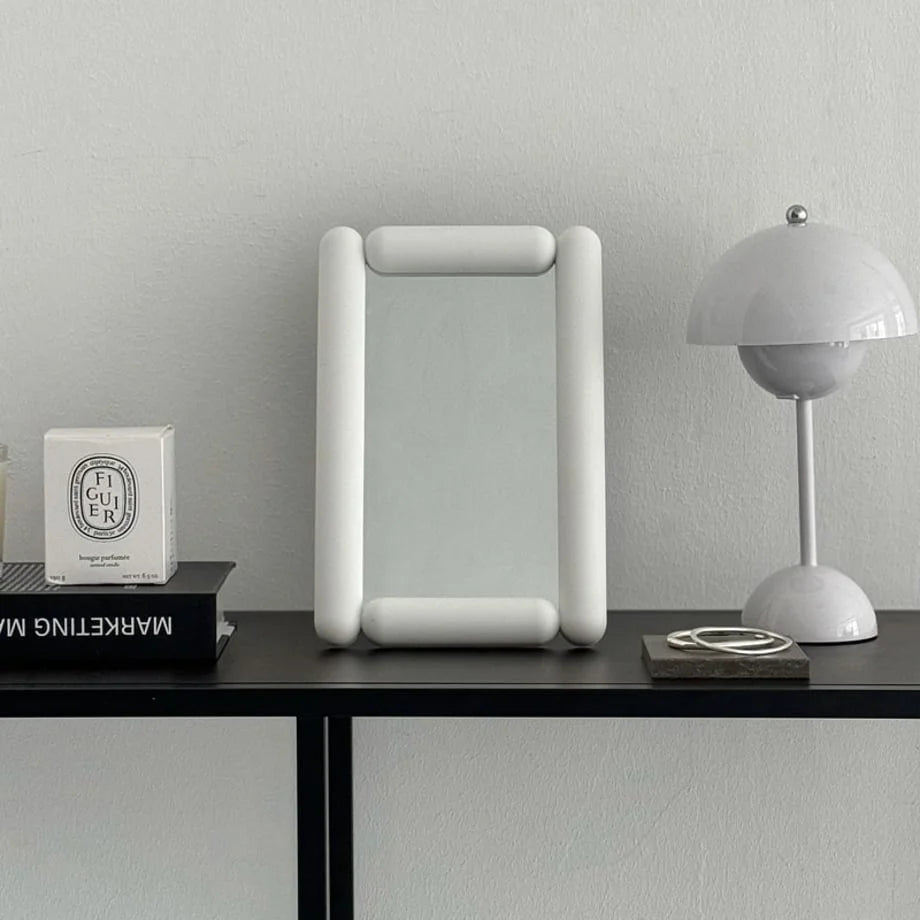 Front view of the white pill-shaped melamine mirror. - RoomDen