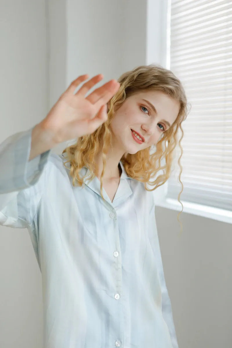 Close up of model waving in Silky Blue Pajama Set - RoomDen