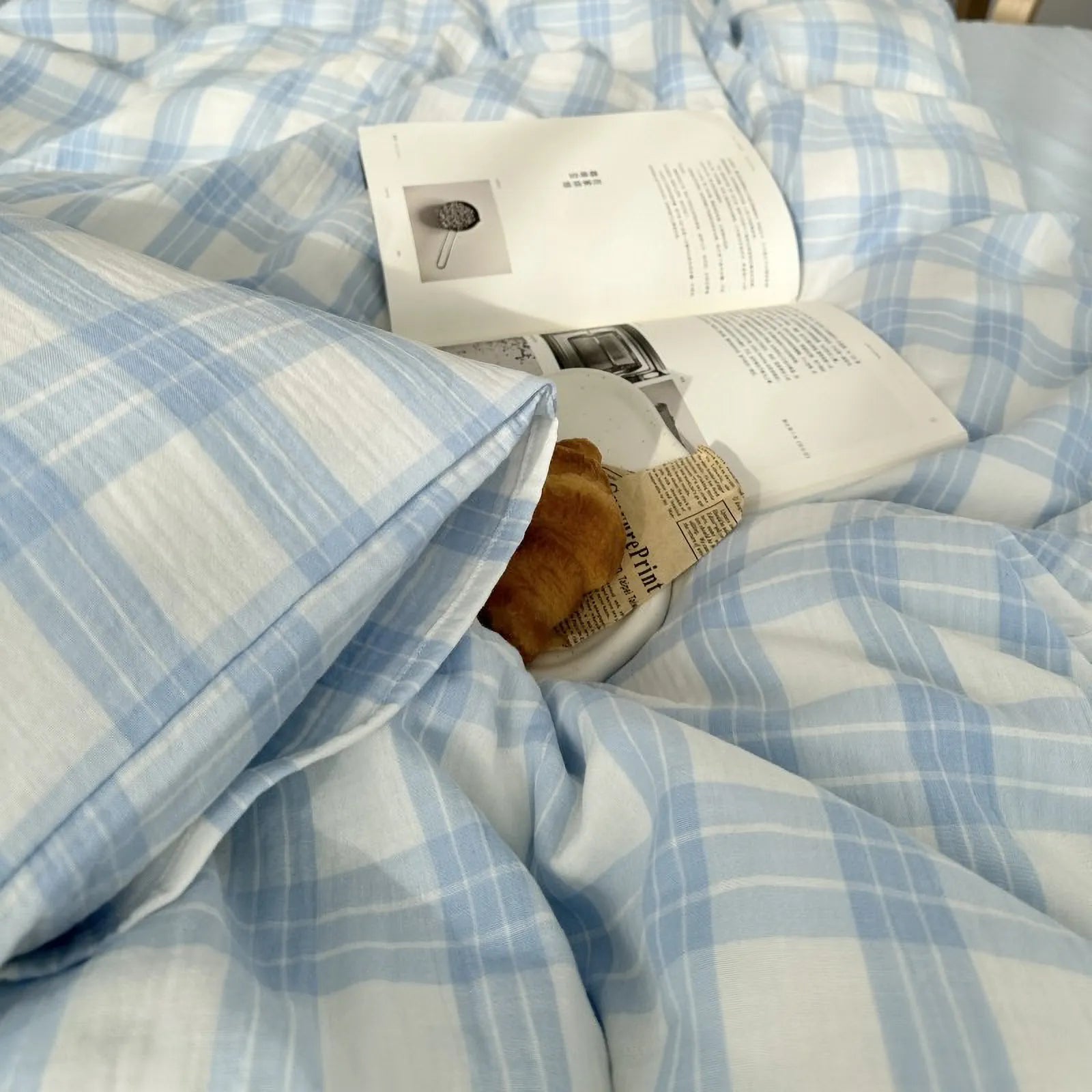 Detail shot showing the corner of a pillow from the sky blue gingham plaid bedding set, highlighting the fabric's texture.