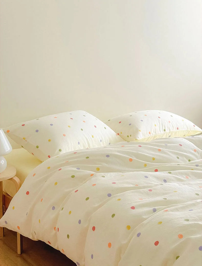 Textured Colorful Polka Dot Washed Cotton Bedding Set on a bed in a brightly lit room - RoomDen