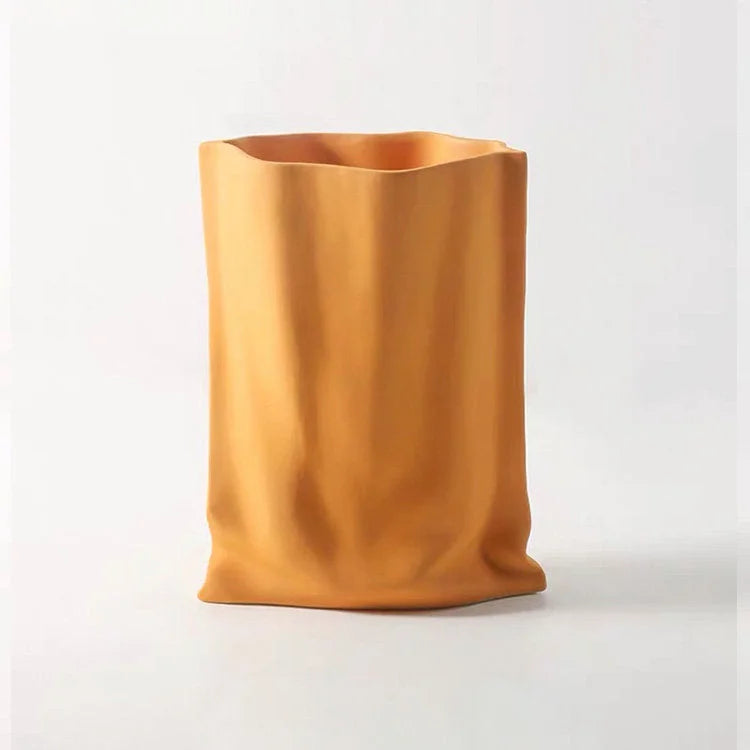 Front view of the Frosted Ruched Ceramic Paper Bag Vase in a bold Tangerine orange color against a white background - RoomDen.