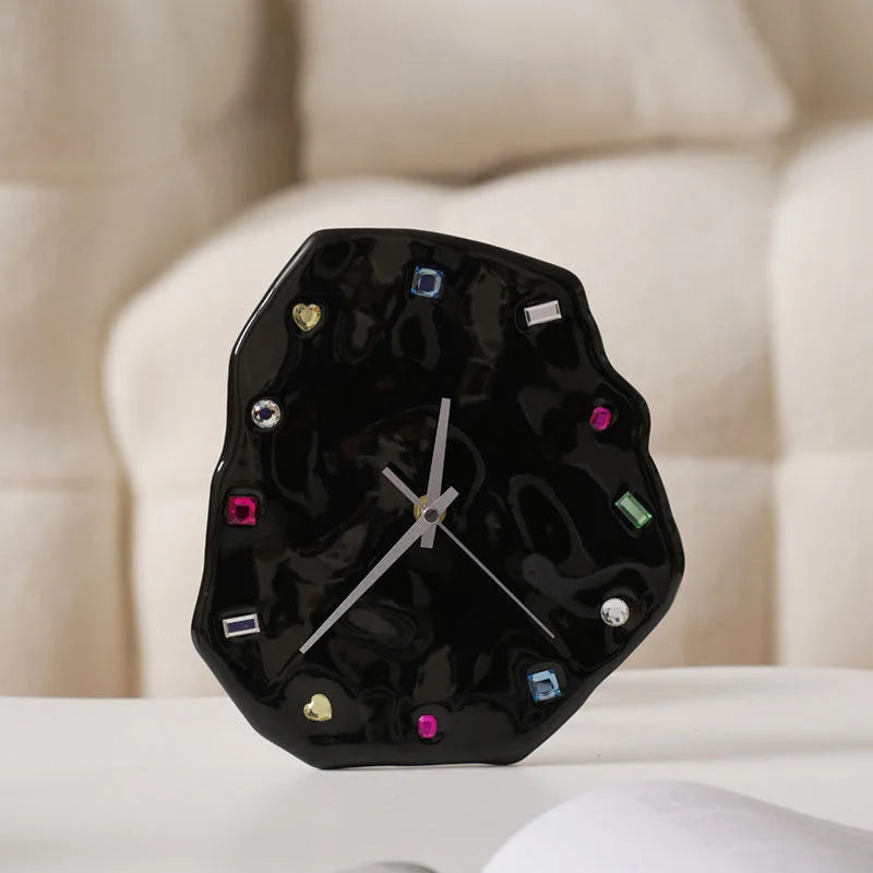 Close-up of the Wavy Jeweled Ceramic Clock in Black, with silver hands and colorful gem markers - RoomDen