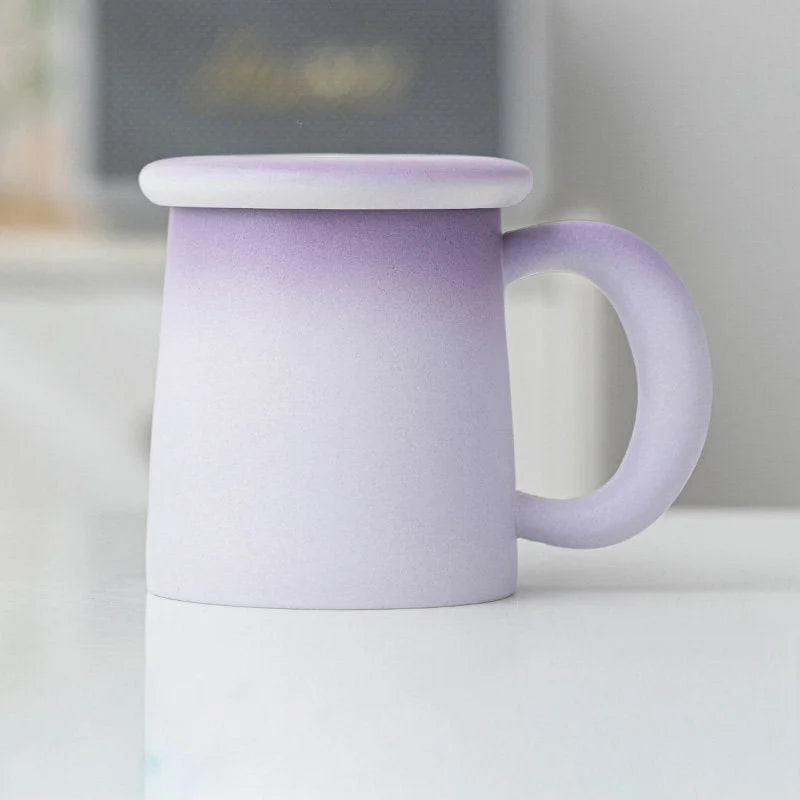 Angled view of the Lavender Ombre Frosted Ceramic Mug with lid - RoomDen.