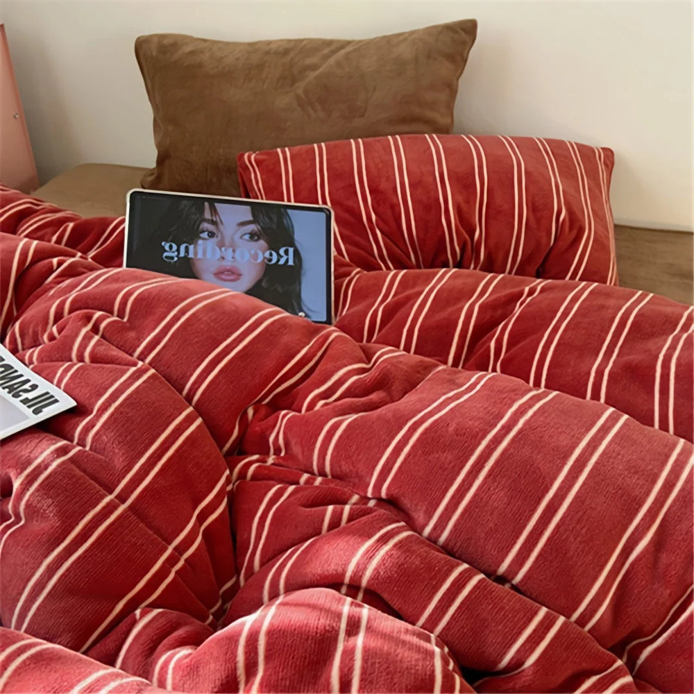 Close-up lifestyle shot of the Plush Pinstripe Velvet Bedding Set in red, with a tablet showing a face on the bed - RoomDen