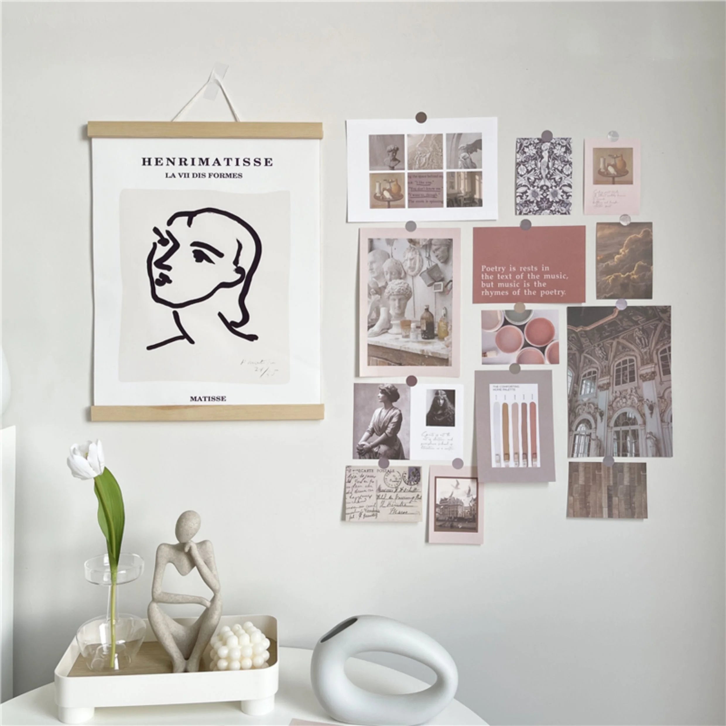 The collage kit styled in a room with a Matisse poster, demonstrating how it pairs with other wall art.