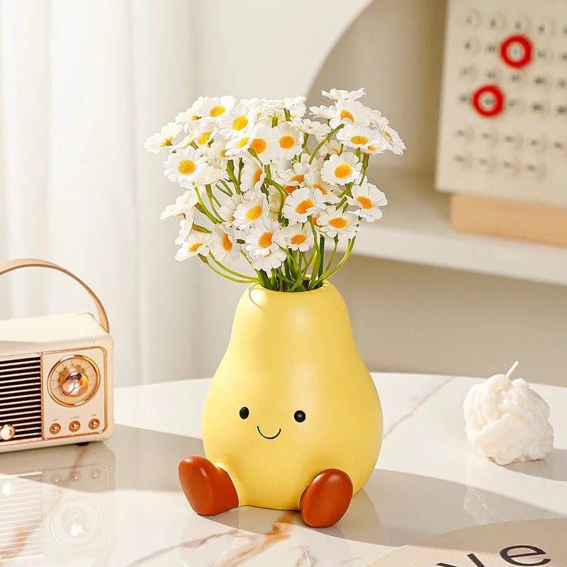 The Cheerful Smiley Face Ceramic Pear Vase shown with white and yellow daisies, highlighting its cute expression - RoomDen.