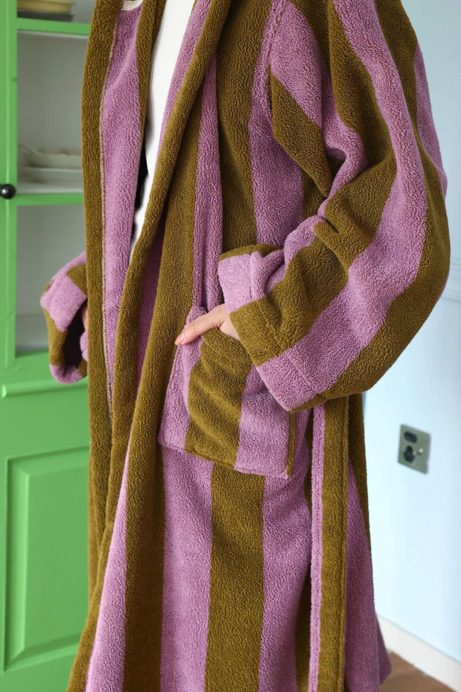 Close up detail of the deep patch pocket on a textured cotton terry cloth robe.