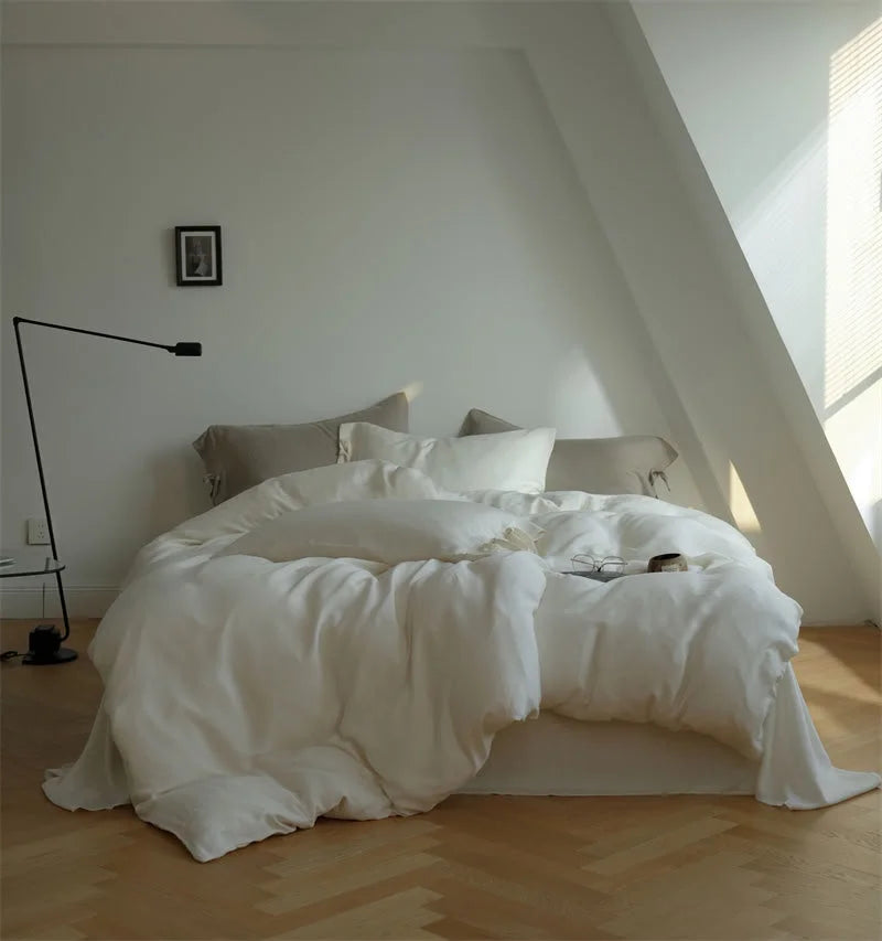 Wide shot of the Creamy White Tencel Bedding Set with a floor lamp in a Japandi-style room - RoomDen
