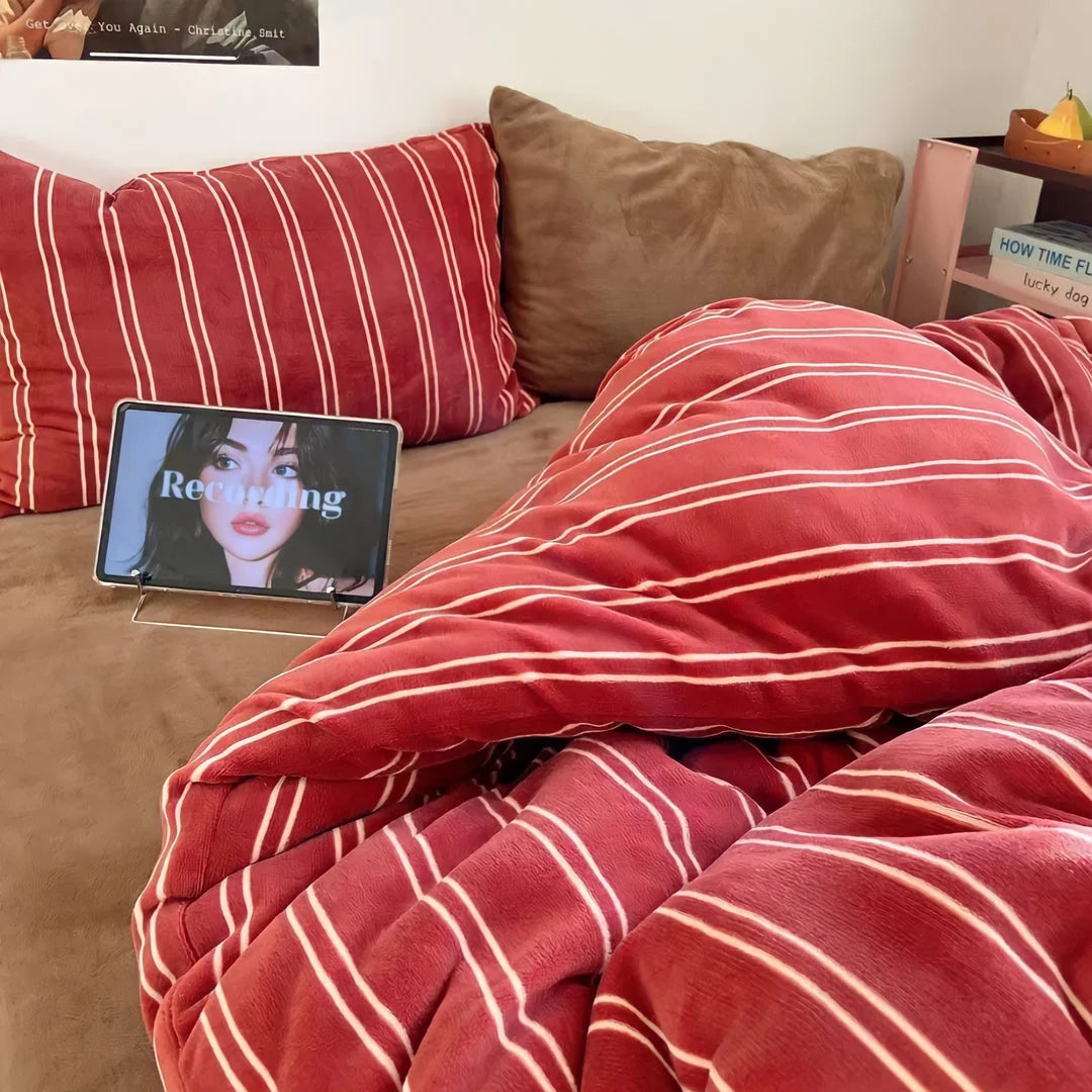 Wide shot of the red pinstripe plush bedding on a bed, creating a warm and inviting dorm room aesthetic - RoomDen