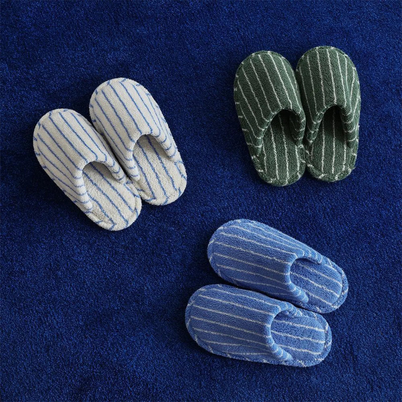 RoomDen Soft Terry Pinstripe Cotton House Slippers in Blue Green and White colorways on blue rug