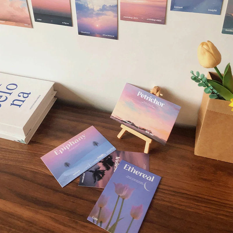 Close-up of the Dreamy Landscape & Word Art cards from the wall collage kit on a desk - RoomDen